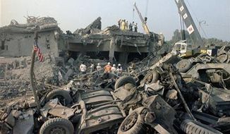 The aftermath of a suicide truck bombing of the U.S. Marines barracks in Beirut, Lebanon on Sunday, Oct. 23, 1983. The blast claimed the lives of 241 American service members. (AP Photo/Jim Bourdier, File)