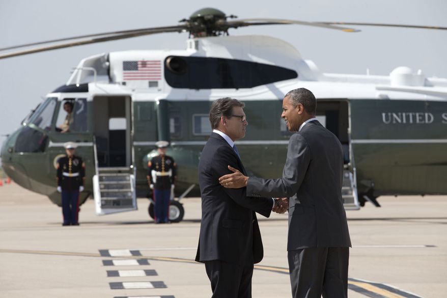 President Barack Obama is greeted by Texas Gov. Rick Perry as he arrives at Dallas/Fort Worth International Airport, Wednesday, July 9, 2014. The president is expected to attend a meeting on immigration, (AP Photo/Jacquelyn Martin)