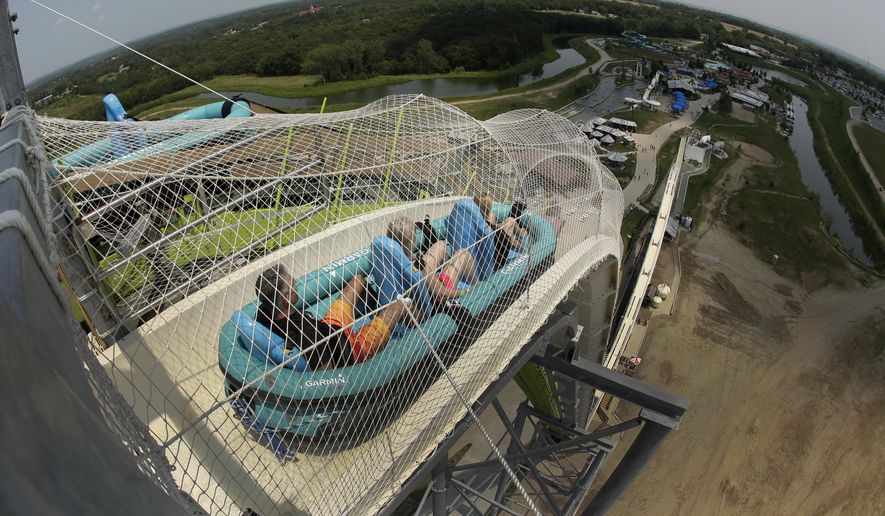 In this photo taken with the fisheye lens, riders go down the world's tallest water slide called "Verruckt" at Schlitterbahn Waterpark, Wednesday, July 9, 2014, in Kansas City, Kan. (AP Photo/Charlie Riedel) ** FILE **