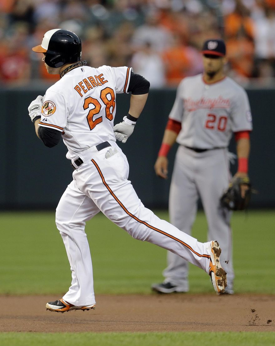 Baltimore Orioles&#x27; Steve Pearce rounds the bases past Washington Nationals shortstop Ian Desmond after hitting a solo home run in the first inning of an interleague baseball game, Thursday, July 10, 2014, in Baltimore. (AP Photo/Patrick Semansky)
