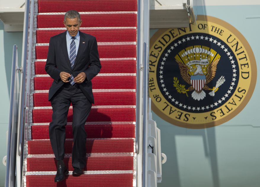 President Barack Obama jogs down the ramp of Air Force One as he arrives Andrews Air Force Base, Md., Thursday, July 10, 2014. (AP Photo/Manuel Balce Ceneta)