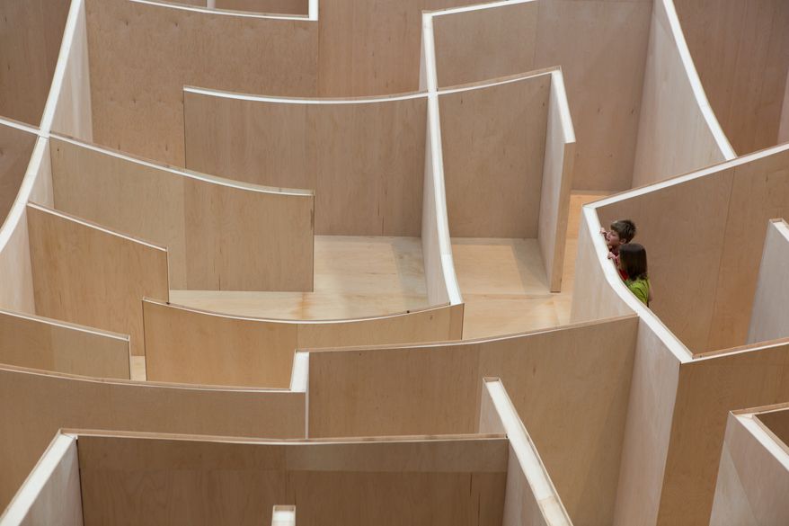 Visitors to the National Building Museum walk through the large-scale Big Maze Thursday morning. The maze was inspired by the ancient history of mazes and will be open to the public until September, 1. Keith Lane/Special to the Washington Times