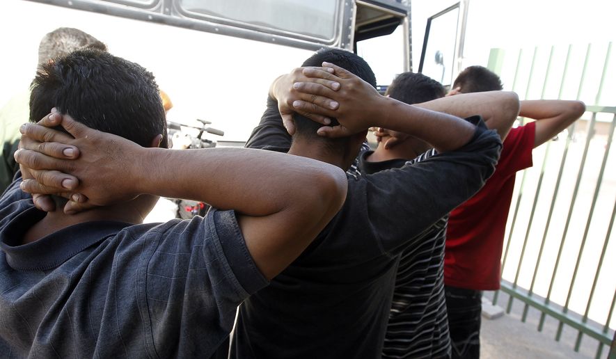 Newly arrived people who were caught in Arizona by the U.S. Border Patrol are initially processed at Tucson Sector U.S. Border Patrol headquarters in Tucson, Ariz., on Aug. 9, 2012. (Associated Press) **FILE**