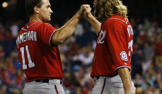 Washington Nationals&#39; Ryan Zimmerman, left, and Jayson Werth celebrate after Zimmermann hit the go-ahead RBI-single in the 10th inning of a baseball game against the Philadelphia Phillies, Saturday, July 12, 2014, in Philadelphia. Washington won 5-3 in 10 innings. (AP Photo/Matt Slocum)