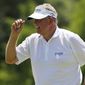 Colin Montgomerie gestures to the gallery following his putt on the second green during the final round of the U.S. Senior Open golf tournament at Oak Tree National in Edmond, Okla., Sunday, July 13, 2014. (AP Photo/Sue Ogrocki)