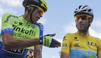 Spain&#39;s Alberto Contador gestures when talking to Italy&#39;s Vincenzo Nibali, wearing the overall leader&#39;s yellow jersey, prior to the start of the third stage of the Tour de France cycling race over 155 kilometers (96.3 miles) with start in Cambridge and finish in London, England, Monday, July 7, 2014. (AP Photo/Christophe Ena)
