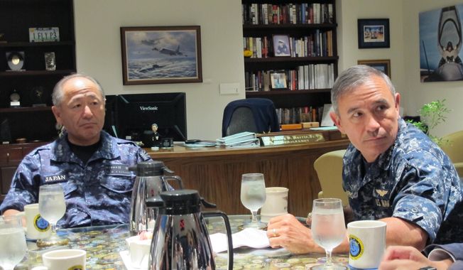 Japanese navy commander Adm. Katsutoshi Kawano, left, and U.S. Pacific Fleet commander Adm. Harry Harris listen to a reporter&#x27;s question in Pearl Harbor, Hawaii on Monday, July 14, 2014. The admirals, meeting on the sidelines of the world&#x27;s largest maritime exercises, say cooperation between their two navies is deepening. (AP Photo/Audrey McAvoy)