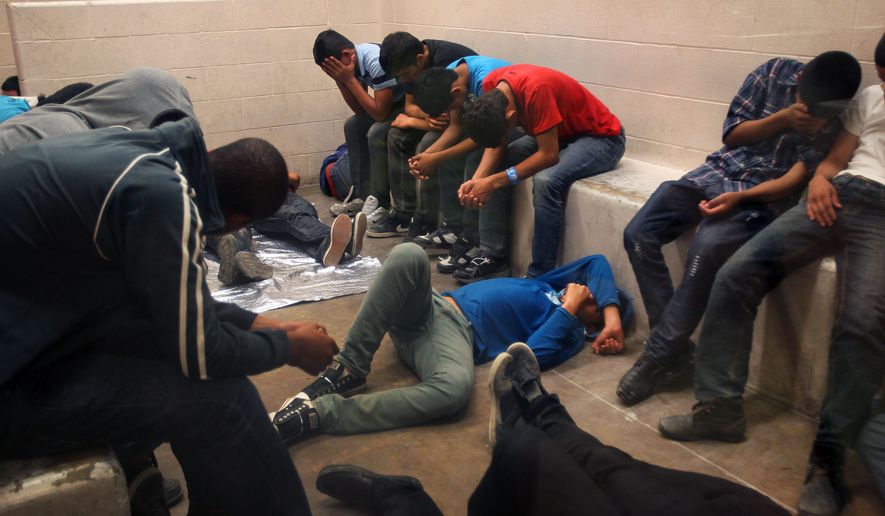 Immigrants who have been caught crossing the border illegally are housed inside the McAllen Border Patrol Station in McAllen, Texas where they are processed on Tuesday, July 15, 2014.  More than 57,000 unaccompanied children have been apprehended at the southwestern border since October, more than twice the total this time last year, many through the Rio Grande Valley. (AP Photo/Los Angeles Times,  Rick Loomis, Pool) 