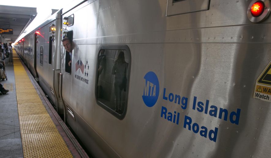 A conductor checks the platform from his train at the Jamaica station of the Long Island Rail Road, in the Queens borough of New York, Wednesday, July 16, 2014. Negotiations aimed at avoiding a walkout at the nation's largest commuter railroad resumed Wednesday after Gov. Andrew Cuomo prodded both sides to find an agreement that would keep 300,000 daily riders from being forced to find alternate ways of getting in and out of New York City. (AP Photo/Richard Drew)