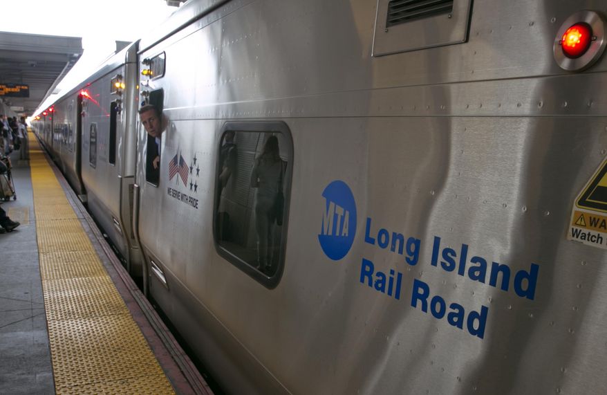 A conductor checks the platform from his train at the Jamaica station of the Long Island Rail Road, in the Queens borough of New York, Wednesday, July 16, 2014. Negotiations aimed at avoiding a walkout at the nation's largest commuter railroad resumed Wednesday after Gov. Andrew Cuomo prodded both sides to find an agreement that would keep 300,000 daily riders from being forced to find alternate ways of getting in and out of New York City. (AP Photo/Richard Drew)