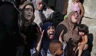 In Gaza City, Palestinian relatives grieve for four boys from the same extended Bakr family. The cousins, ages 9 to 11, were killed while playing on a beach. (Associated Press photographs)