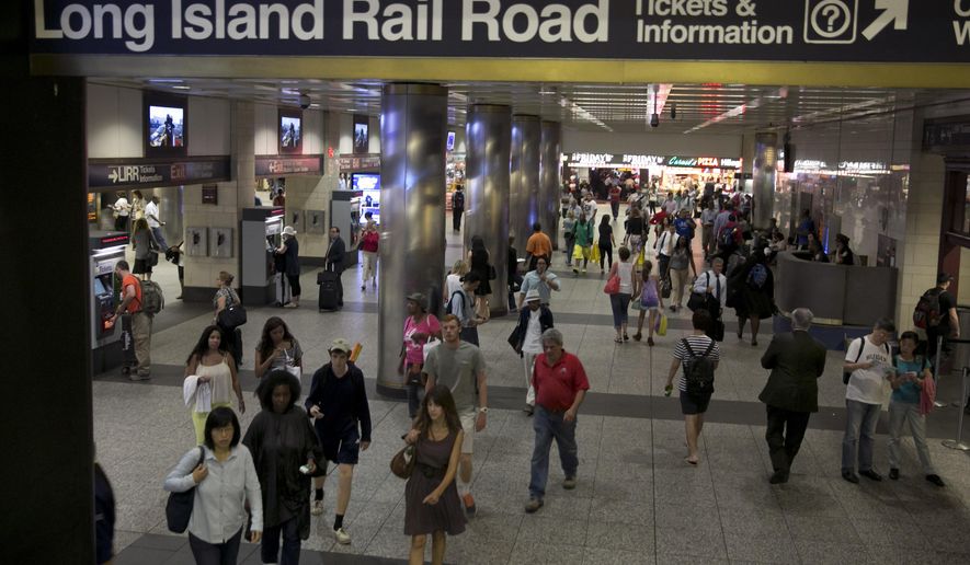 Passengers walk through the Long Island Rail area of New York's Penn Station, Wednesday, July 16, 2014. Negotiations aimed at avoiding a walkout at the nation's largest commuter railroad resumed Wednesday after Gov. Andrew Cuomo prodded both sides to find an agreement that would keep 300,000 daily riders from being forced to find alternate ways of getting in and out of New York City. (AP Photo/Richard Drew)
