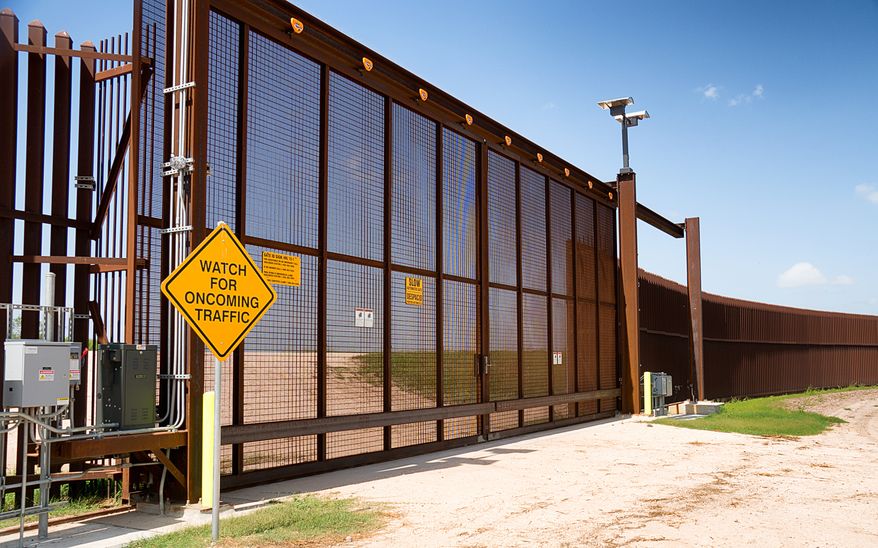 The fence marking the border between Mexico and the United States is photographed on Wednesday, July 16, 2014, in La Paloma,Texas. Democratic opposition increased Wednesday to legal changes that would speed removals of young Central American migrants, jeopardizing President Barack Obama's call for $3.7 billion in emergency border spending to deal with the remarkable surge of unaccompanied youths at the South Texas border (AP Photo/Valley Morning Star, David Pike)