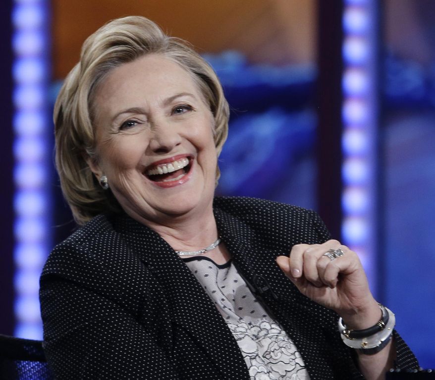 In this July 15, 2014, photo, former U.S. Secretary of State Hillary Rodham Clinton reacts to host Jon Stewart during a taping of "The Daily Show with Jon Stewart," in New York. As Clinton promotes her book, liberals in the Democratic party are elbowing into the 2016 presidential conversation while pitching populist messages on the economy and immigration. (AP Photo/Frank Franklin II)