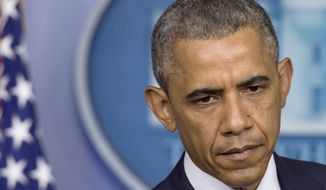 President Obama pauses while speaking about the situation in Ukraine in the Brady Press Briefing Room of the White House on July 18, 2014. Obama called for immediate ceasefire in Ukraine, demands credible investigation of downed plane. (Associated Press)