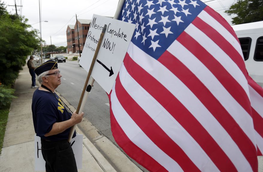 ** FILE ** Protesters gather outside the Mexican Consulate, Friday, July 18, 2014, in Austin, Texas. (AP Photo/Eric Gay)