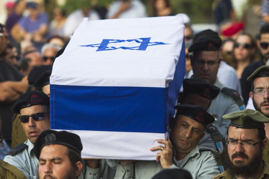 Israeli soldiers carry the coffin of Maj. Amotz Greenberg, 45, during his funeral in the Israeli city of Hod Hasharon, Sunday, July 20, 2014. According to reports, Greenberg was killed fighting a group of militants who infiltrated Israel through a tunnel from the Gaza Strip. (AP Photo/Dan Balilty)
