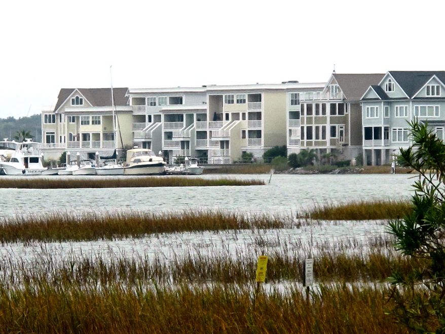 FILE - In this Nov. 14, 2012 file photograph a development along the Intracoastal Waterway in Mount Pleasant, S.C., is seen. On Monday, July 25, 2014, the nonprofit group Climate Central released a new report that sea level rise is expected to contribute to extreme floods along the South Carolina coast in the next four decades. The report concluded that $24 billion in property and 54,000 homes are at risk. (AP Photo/Bruce Smith, File)