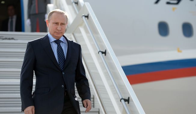 Russian President Vladimir Putin steps down upon his arrival at the airport of Samara, Russia, Monday, July 21, 2014. Putin has lambasted those who use the downing of a passenger jet in eastern Ukraine for &quot;mercenary objectives,&quot; the Kremlin said Monday. In a statement posted on the Kremlin website, Putin again lashed out at Ukraine for ongoing violence with pro-Russian rebels in the eastern part of the country. (AP Photo/RIA-Novosti, Alexei Nikolsky, Presidential Press Service)