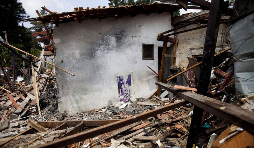 A destroyed house that was hit by a rocket fired by Palestinian militants from Gaza, in Yahud, a Tel Aviv suburb near the airport, central Israel, Tuesday, July 22, 2014. As a result, Delta Air Lines and U.S. Airlines decided to cancel their scheduled flights to Israel.(AP Photo/Dan Balilty)