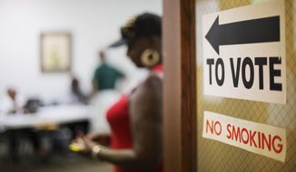 A sign directs voters at a polling site, Tuesday, July 22, 2014, in Atlanta. Voters head to the polls on Tuesday to decide the U.S. Senate GOP runoff between Jack Kingston and David Perdue. The winner will face Democrat Michelle Nunn in November. In addition to the high-profile GOP U.S. Senate runoff, voters in Georgia on Tuesday will cast ballots in a number of other races, including four U.S. House runoffs and state school superintendent. (AP Photo)