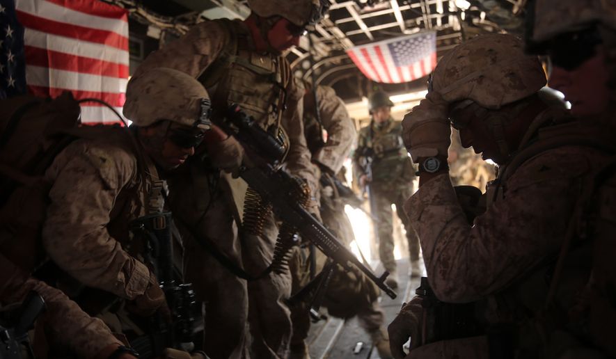 U.S. Marines with Bravo Company, 1st Battalion, 7th Marine Regiment board a CH-53E Super Stallion helicopter during a mission July 5, 2014, in Gereshk, Helmand province, Afghanistan.  U.S. Marine Corps photo.