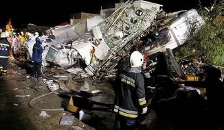 Rescue workers survey the wreckage of TransAsia Airways flight GE222, which crashed while attempting to land in stormy weather on the Taiwanese island of Penghu. Experts say the airline industry will stay healthy despite several recent tragedies. (Associated Press)