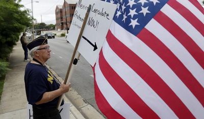 ** FILE ** Protesters gather outside the Mexican Consulate, Friday, July 18, 2014, in Austin, Texas. (AP Photo/Eric Gay)