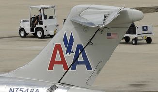 A ramp worker rolls past an American Airlines McDonnell Douglas MD-82 at the Tampa International Airport in Tampa , Fla., on May 15. (Associated Press)