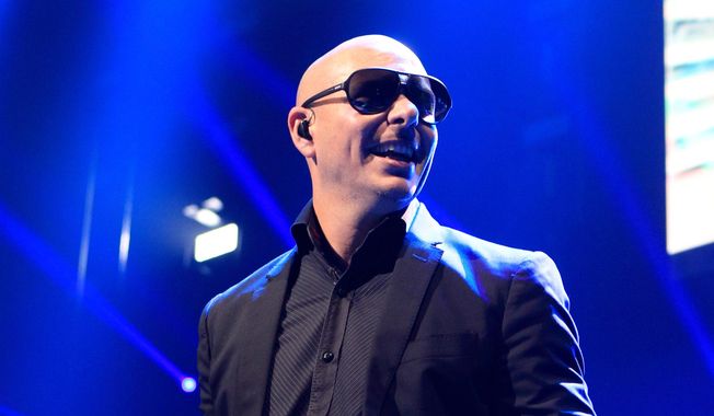 This Dec. 4, 2013, file photo shows Pitbull performing in concert during the Q102 Jingle Ball at the Wells Fargo Center in Philadelphia. (Photo by Owen Sweeney/Invision/AP, File)