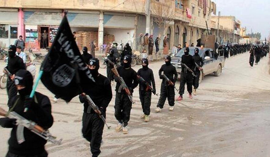 ** FILE ** This undated file image posted on a militant website on Tuesday, Jan. 14, 2014, which has been verified and is consistent with other AP reporting, shows fighters from the Islamic State of Iraq and the Levant (ISIL) marching in Raqqa, Syria. (AP Photo/Militant Website, File)