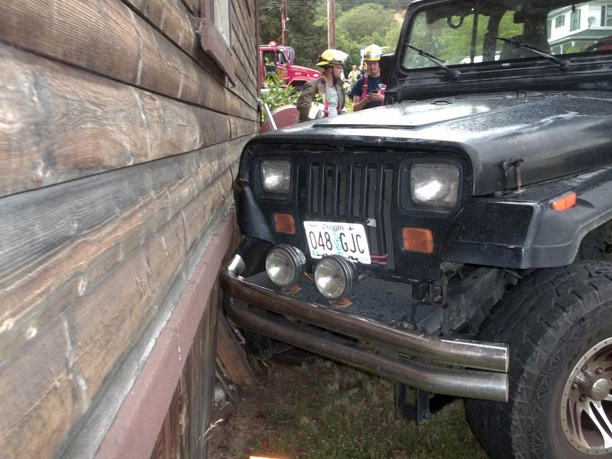 This photo provided by the Myrtle Creek Police Department shows a Jeep that authorities say a toddler crashed into an home in Myrtle Creek, Ore. The 3-year-old boy wearing only a diaper climbed into the Jeep on Tuesday, July 24, 2014, and knocked it out of gear, according to authorities. Witnesses said it rolled down the street, through an intersection and into the house, causing minor damage. After the crash authorities said the toddler ran back to his home to watch cartoons. (AP Photo/Myrtle Creek Police Department)