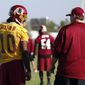 Washington Redskins quarterback Robert Griffin III talks with head coach Jay Gruden during practice at the team&#39;s NFL football training facility, Friday, July 25, 2014 in Richmond, Va. (AP Photo)