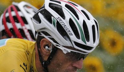 Italy's Vincenzo Nibali, wearing the overall leader's yellow jersey, rides in the rain during the nineteenth stage of the Tour de France cycling race over 208.5 kilometers (129.6 miles) with start in Maubourguet and finish in Bergerac, France, Friday, July 25, 2014. (AP Photo/Christophe Ena)