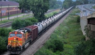In this July 25, 2014 photo, an oil train moves through the area South of St Paul, Minn.  Railroad documents released by the state Department of Public Safety show about 50 trains carrying crude oil from North Dakota are passing through Minnesota each week. The documents obtained by The Associated Press were first reported Saturday, July 26 by the Star Tribune. (AP Photo/The Star Tribune, Connor Lake)  MANDATORY CREDIT; ST. PAUL PIONEER PRESS OUT; MAGS OUT; TWIN CITIES LOCAL TELEVISION OUT