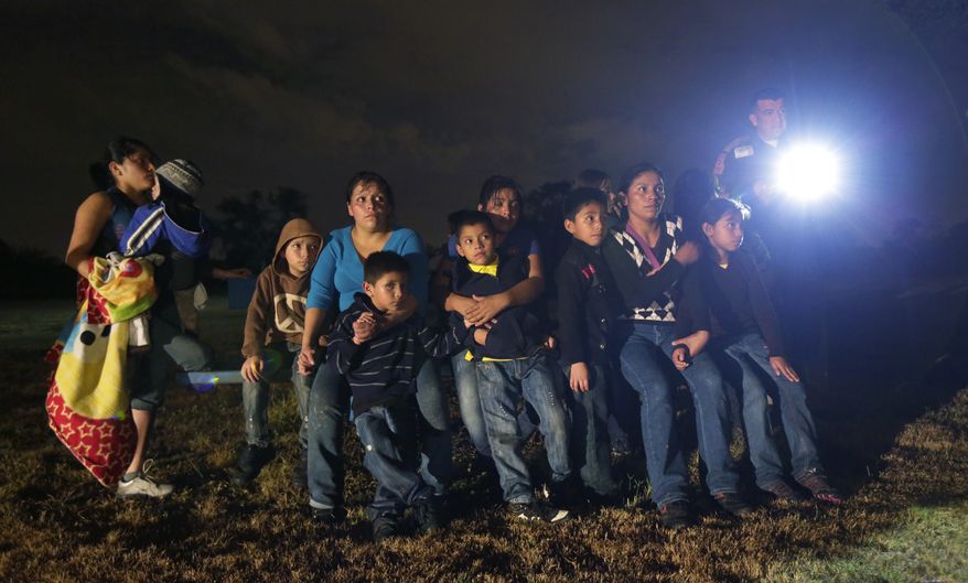 A group of illegal immigrants from Honduras and El Salvador who crossed the U.S.-Mexico border illegally are stopped in Granjeno, Texas, June 25, 2014. (AP Photo/Eric Gay) ** FILE **  