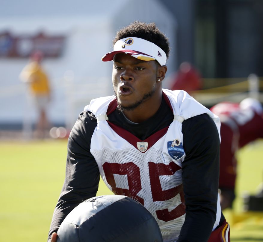 Washington Redskins receiver Leonard Hankerson works with a medicine ball during practice at the team's NFL football training facility, Monday, July 28, 2014 in Richmond, Va. (AP Photo/Alex Brandon)
