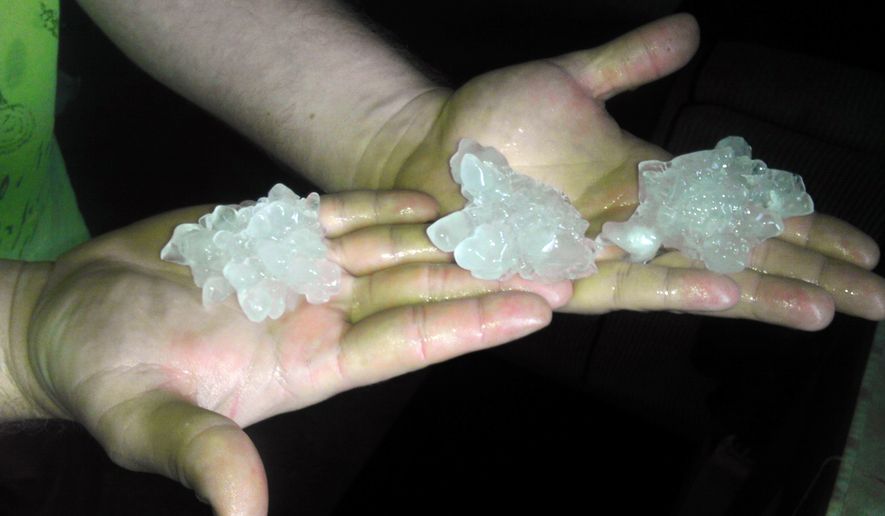This Sunday, July 27, 2014 photo provided by Ben Ferren shows large hail that fell in Midland, Mich., where winds toppled trees and ripped the roofs off buildings during severe thundertorms on Sunday. Crews are working to restore power after severe thunderstorms hit Michigan&#39;s Lower Peninsula and knocked out power to about 223,000 homes and businesses. (AP Photo/Ben Ferren)