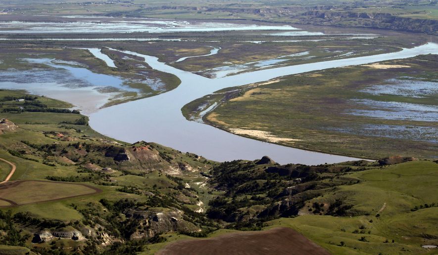 In this June 12, 2014 aerial photo, the Missouri River winds through the countryside near Williston, N.D. The epicenter of the oil boom is a 45-mile stretch of U.S. Route 85 in North Dakota between the towns of Williston and Watford City. (AP Photo/Charles Rex Arbogast)