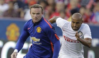 Manchester United&amp;#8217;s Wayne Rooney, front moves the ball as Inter Milan&amp;#8217;s Jonathan, right, defends during the first half of a soccer game at  the 2014 Guinness International Champions Cup, Tuesday, July 29, 2014, in Landover, Md.  Manchester United won 5-3 in a penalty shootout. (AP Photo/Luis M. Alvarez)