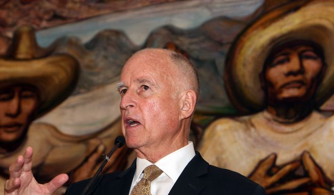 Back-dropped by a mural by Mexican painter David Alfaro Siqueiros, California Gov. Jerry Brown speaks during a press conference with U.S. Ambassador to Mexico Anthony Wayne, not seen, at the Soumaya museum in Mexico City, Monday, July 28, 2014. (AP Photo/Marco Ugarte)