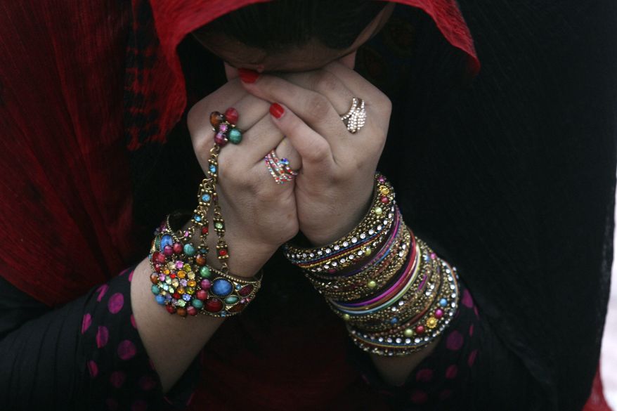 **FILE** A Pakistani prays at the Badshahi mosque to offer the Eid al-Fitr prayer at the beginning of a major holiday marking the end of the fasting month of Ramadan in Lahore, Pakistan, Tuesday, July 29, 2014. Millions of Muslims across the world are celebrating the Eid. (K.M. Chaudary)