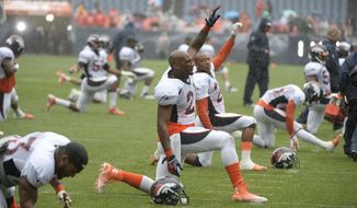 Denver Broncos cornerback Aqib Talib (21) stretches in the  rain at Broncos NFL football training camp in Denver, Wednesday, July 30, 2014. (AP Photo/The Denver Post, J) MAGS OUT; TV OUT; INTERNET OUT; NO SALES; NEW YORK POST OUT; NEW YORK DAILY NEWS OUT