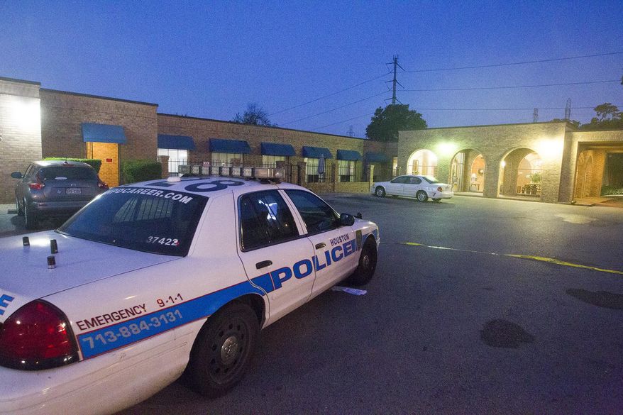 **FILE** Houston Police investigate the scene of a homicide at a nursing home in Houston on April 23, 2014. (Associated Press/Houston Chronicle, Cody Duty)
