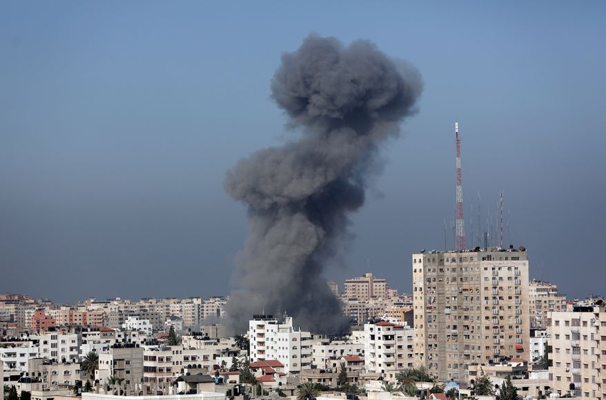 Smoke from the explosion of an Israeli strike rise over Gaza City, Wednesday, July 30, 2014, amid Israel's heaviest air and artillery assault in more than three weeks of Israel-Hamas fighting. (AP Photo/Khalil Hamra)
