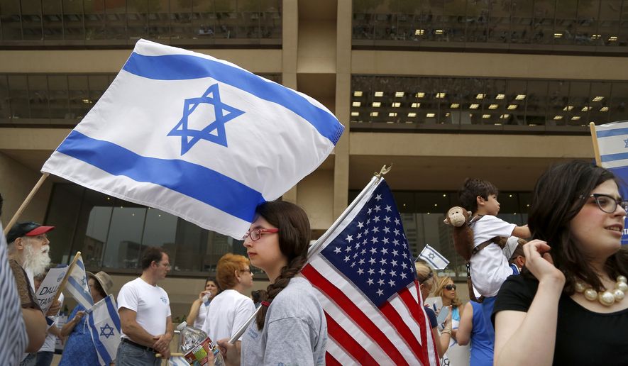 Lily Goldberg, 13, center, holds a United States flag during a rally in support of Israel in front of city hall in Dallas, Texas, on Wednesday, July 30, 2014. Texas Gov. Rick Perry spoke at the rally, criticizing an American "policy of calculated ambivalence" toward Israel, a nod toward conservative voters as he considers a second run for president. (AP Photo/The Dallas Morning News, Brad Loper) MANDATORY CREDIT; NO SALES; MAGAZINES OUT; TV OUT; INTERNET USE BY AP MEMBERS ONLY