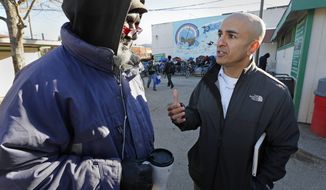 FILE - In this Dec. 4, 2013 file photo, Neel Kashkari, right, who later won the Republican nomination for governor of California, talks with Kenneth Whitaker, 62, at Loaves and Fishes homeless shelter in Sacramento, Calif. In a July 31, 2014 opinion piece published in the Wall Street Journal, Kashkari said he spent a week living as a homeless person in search of a job to test Gov. Jerry Brown&#x27;s claim that the state is making a comeback after the economic downturn. (AP Photo/Rich Pedroncelli, File)