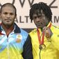 In this image taken Sunday July 27, 2014 Australia&#39;s Francois Etoundi  bronze medal winner, left, stands on the podium with gold medal winner India&#39;s Sathish Sivalingam following the men&#39;s 77kg weightlifting final at the Commonwealth Games Glasgow 2014  in Glasgow Scotland.  Etoundi,  was stripped of his games accreditation Thursday July 31, 2014  after being arrested over an alleged assault during an altercation in the athletes&#39; village in Glasgow.  (AP Photo/Dominic Lipinski/PA)   UNITED KINGDOM OUT