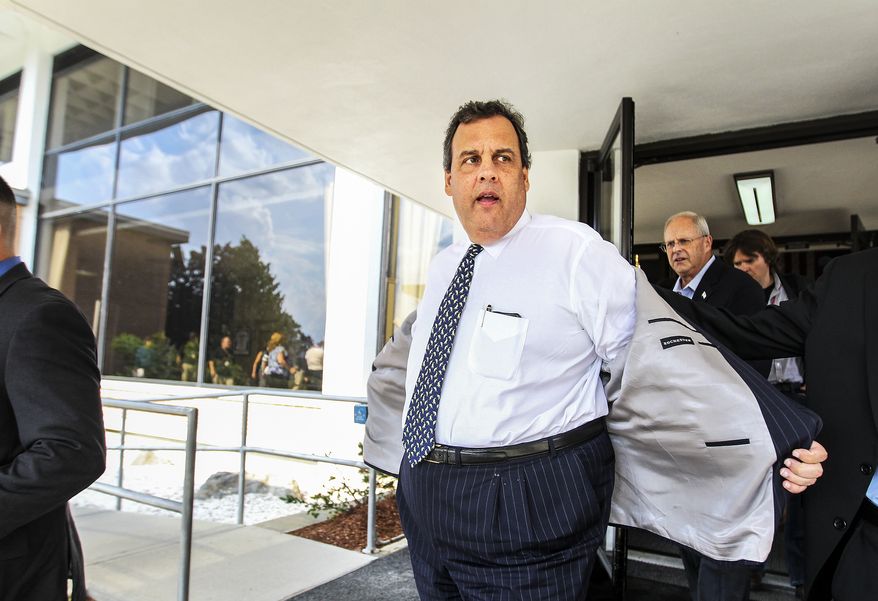 New Jersey Gov. Chris Christie, center, heads out of BAE Systems in Nashua, N.H. after stumping for Republican candidate for governor of New Hampshire, Walt Havenstein, second from right, on Thursday, July 31, 2014. Christie has been traveling around the country boosting Republican candidates in his role as chair of the Republican Governors Association. (AP Photo/Cheryl Senter)