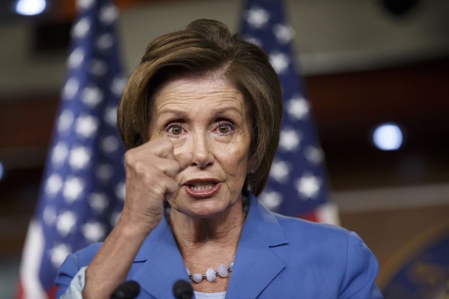 On the last day before Congress takes a five-week summer recess, House Minority Leader Nancy Pelosi of Calif., speaks to reporters on Capitol Hill in Washington, Thursday, July 31, 2014, about Republicans pushing through legislation to launch a campaign-season lawsuit against President Barack Obama, after accusing him of deliberately exceeding the bounds of his constitutional authority. Democrats have branded the effort a political charade and an effort by top Republicans to mollify conservatives who want Obama to be impeached. (AP Photo/J. Scott Applewhite)